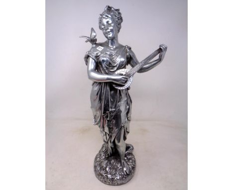 A silvered figure of a lady playing a lute 