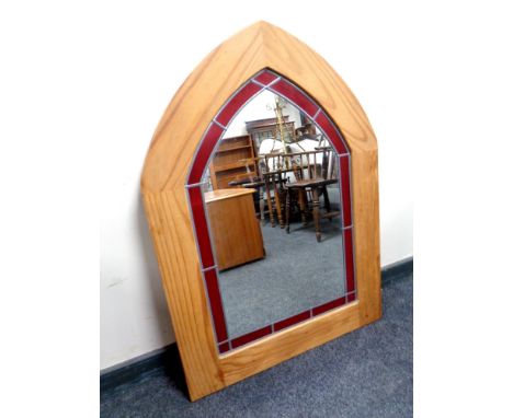 A pine arch topped framed stained leaded glass mirror 