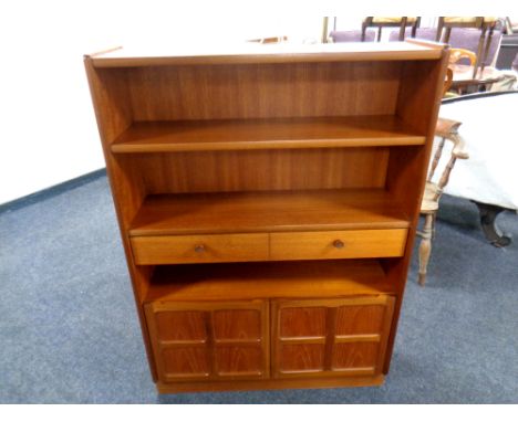 A 20th century Nathan teak book shelf with drawer and double cupboard beneath 