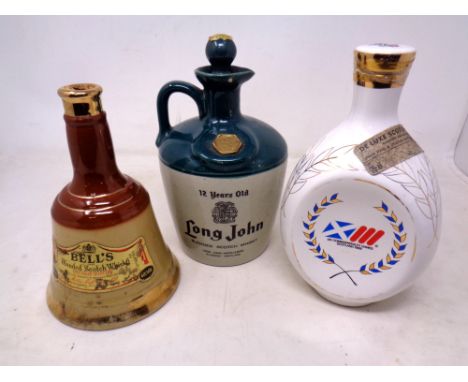 A Bells Blended Scotch Whisky decanter, Dimple Whisky decanter 'The Commonwealth Games 1986' and a 12 Year Old Long John Blen