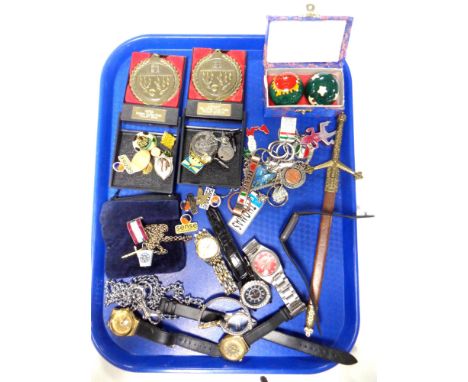 A tray of lady's and gent's wrist watches, enamelled badges, miniature sword in scabbard etc 