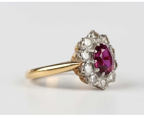 A gold, ruby and diamond oval cluster ring, claw set with the oval cut ruby within a surround of ten circular cut diamonds, d