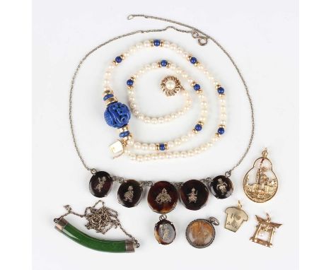 A small group of jewellery, including a cultured pearl and lapis lazuli bead necklace, the front with a carved lapis lazuli s