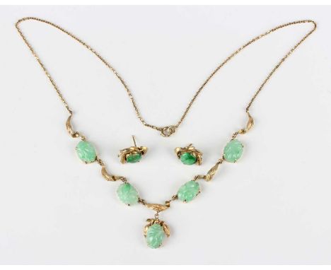 A gold and jade necklace, the five oval jades with carved decoration, otherwise with foliate motifs at intervals, detailed ‘1