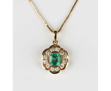 A gold, emerald and diamond pendant, claw set with the cut cornered square step cut emerald within a hexagonal surround set w