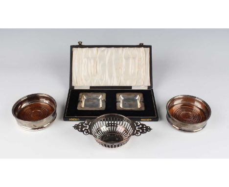  A pair of Elizabeth II silver wine coasters, each with a scroll rim, Birmingham 1975 by Charles S. Green &amp; Co Ltd, diame