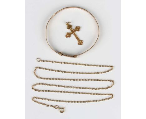 A 9ct gold oval child’s bangle with engraved decoration, Birmingham 1954, inside width 4.8cm, a 9ct gold pendant cross and a 