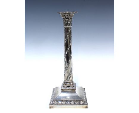 An Edwardian silver candlestick, Sheffield 1904, with a Corinthian capital and trailing foliate pattern, on a square stepped 