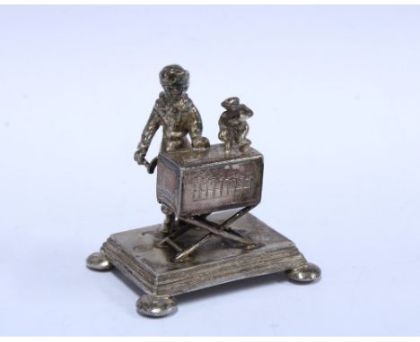 Miniature organ grinder and dancing monkey figure in white metal, makers stamp GS, 5cm