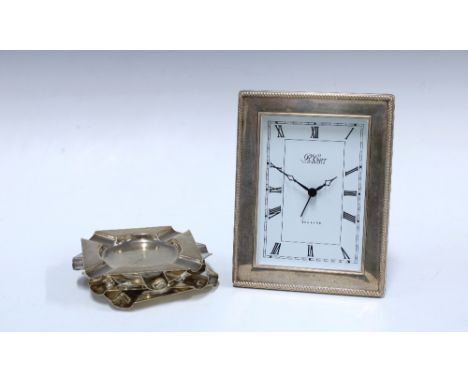 Set of four silver ashtrays, each with a kukri pattern,  Chester 1935 together with a modern silver mounted clock, R. Carr, S