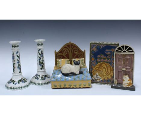 Three studio pottery cat wall plaques, tallest 22cm, together with a pair of Portmeirion Botanic Garden candlesticks (5)