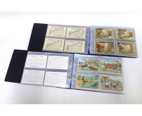Two albums containing Liebig &amp; Cibils trade card sets to include Musical Instruments 1 - 483, Discover of the route to In