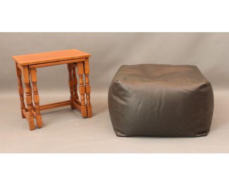 A dark brown faux-leather pouffe and a nest of two light oak tables - the pouffe approx. 53cm high; the larger table 48 x 33c