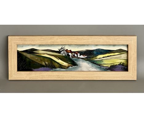Kerry Goodwin for Moorcroft: a framed landscape plaque - decorated with a tubelined scene of a cottage beside a river in a hi