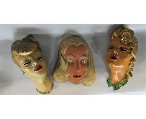 A collection of wall plaques to include to 3 plaster pin-ups in the manner of Goldscheider, futher porcelain example and thre