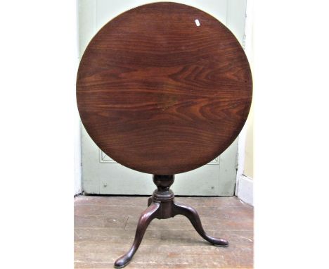 A Georgian mahogany snap top table, the circular top 76 cm in diameter raised on a vase shaped pillar and tripod 