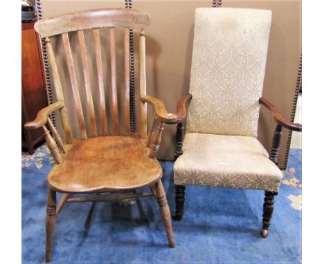 A Windsor elm and beechwood lathe back arm chair with wide generous saddle shaped seat raised on splayed ring turned and tape