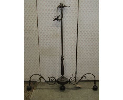 A coated cast metal hanging ceiling light with two scrolling branches, tall knopped stem and three tapered conical milk glass