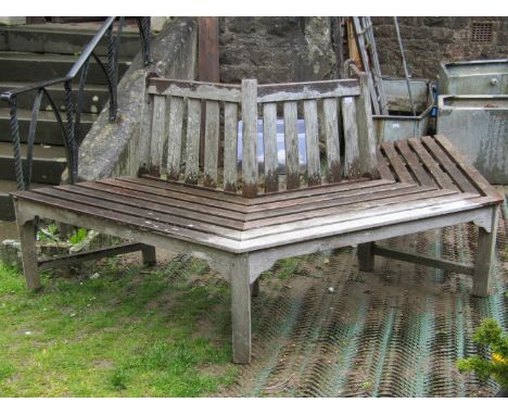 A good quality weathered teak tree bench with slatted seat and back, 230 cm wide x 90 cm high 