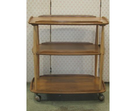 An Ercol three tier tea trolley, principally in elm 