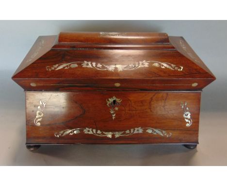 A Regency rosewood and mother of pearl inlaid caddy, the hinged lid enclosing two rosewood lidded boxes and glass mixing bowl