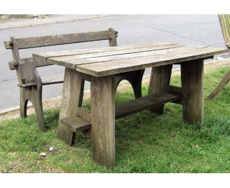 A weathered teak garden table of rectangular form with boarded top 138 cm x 70 cm together with a two seat bench with pegged 