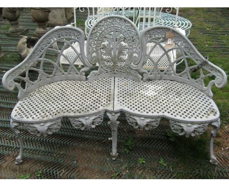 A Victorian style light grey painted cast aluminium three seat garden bench with pierced lattice panelled seat and shaped bac