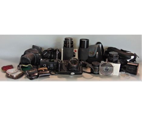 A collection of vintage cameras and optical equipment to include a large Sirius 40-56 lens, a vintage Chinon CM-4s camera and