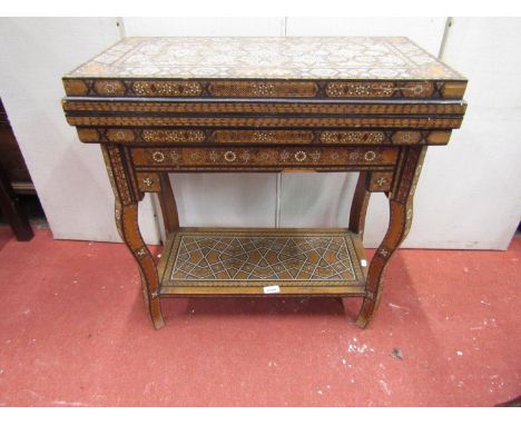 A late 19th century Moroccan foldover top multiple games table, with overall repeating geometric straw-work and ivory detail,