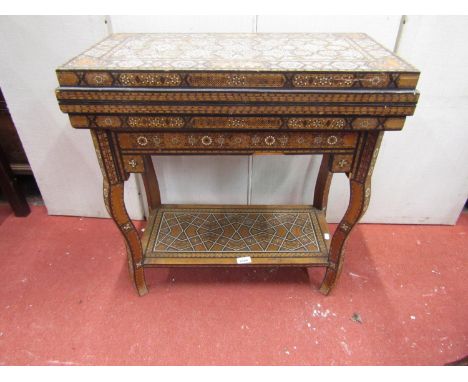 A late 19th century Moroccan foldover top multiple games table, with overall repeating geometric straw-work and ivory detail,