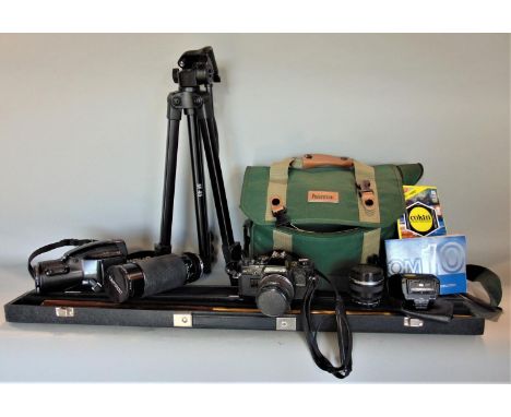 A box containing a collection of vintage camera equipment to include various vintage lenses, an Olympus OM 10 vintage camera,