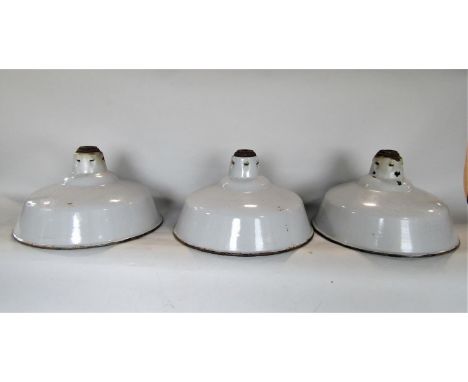 Five industrial enamel lampshades, one in racing green, the others in grey, 32cm diameter, together with a further anglepoise