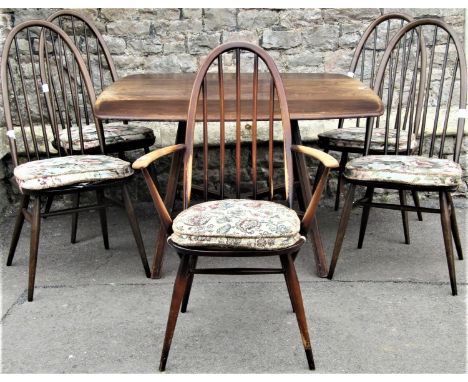 A vintage Ercol dark stained elm and beechwood cottage dropleaf dining table with moulded outline and rounded corners raised 