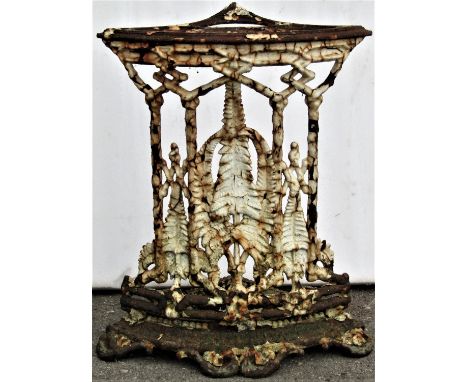 A weathered Victorian cast iron fern pattern corner umbrella/stick stand with four oval divisions 59cm high x 50cm wide 