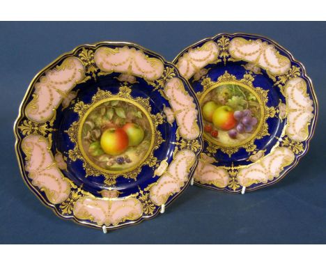 A pair of Royal Worcester cabinet plates with central fruit panels signed R Sebright within pink and blue borders with gilt d