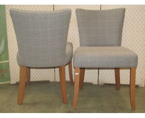 Set of eight contemporary dining chairs with light grey check patterned upholstered seats and curved backs, raised on stained