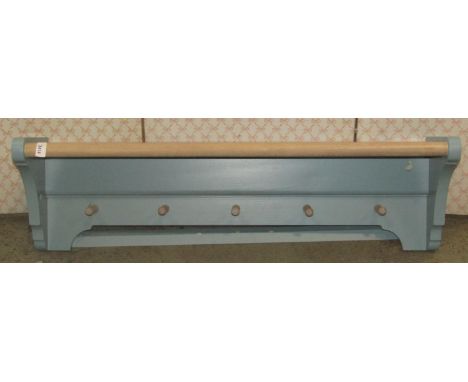 A blue painted wall rack/shelf with five turned pegs, 96cm long x 28cm high 