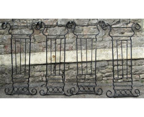 Four lyre shaped sections of iron railing, with ring and simple scroll detail, each panel 50cm wide x 95cm high 