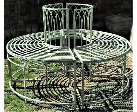 A two sectional Regency style tree bench/seat with arched lattice panels, strap work seats, simple scroll and flower head det