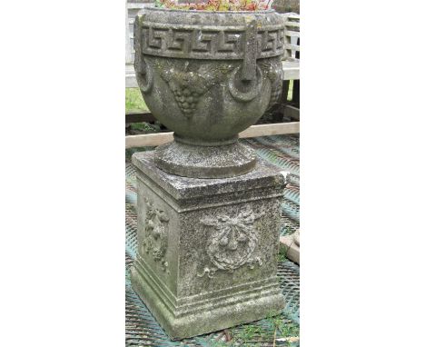 A reclaimed garden planter in the form of a Grecian urn, with Greek key border and trailing and fruiting vine detail, raised 