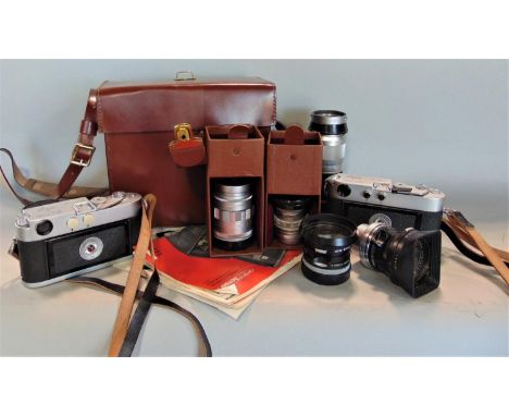 A collection of vintage Leica cameras and lenses to include DBP M4-1273 151, DBP M2 1112496, 1:4/135mm Rangefinder lens, 1:1.