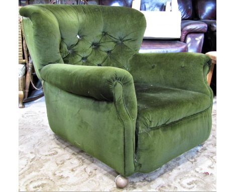 A low vintage deep seated easy chair with rolled arms, button back and upholstered finish 