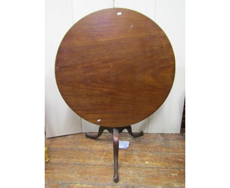 A Georgian mahogany snap top table, the circular one piece top 89cm diameter, raised on a bird cage, turned column and tripod