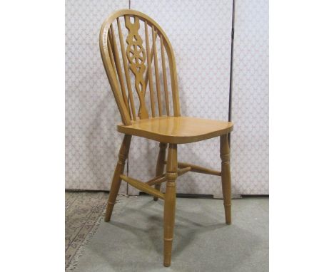 A set of eight modern beechwood Windsor hoop and stick back dining chairs with central pierced wheel splats 