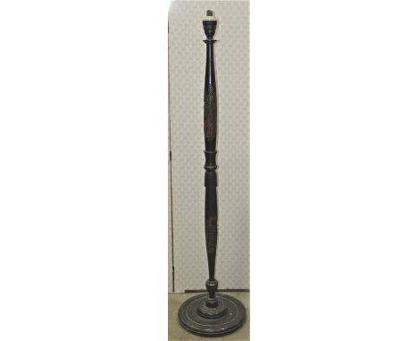 An eastern standard lamp, the turned column with carved detail and raised on a stepped disc shaped platform base, 153 cm high