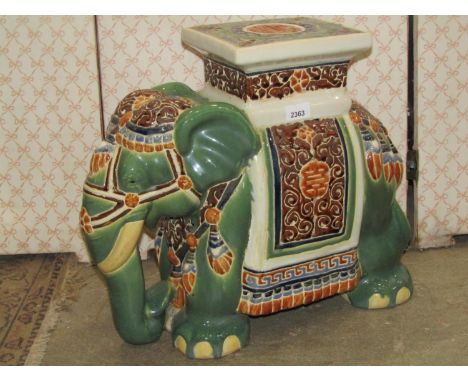 A ceramic garden seat in the form of a elephant with ceremonial headdress 