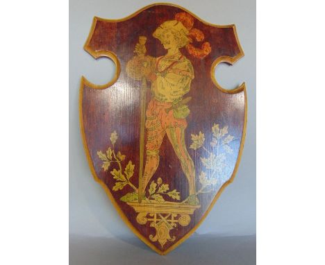 A Sorrento shield shaped wooden panel decorated with a swordsman holding or drinking a glass of wine, 23 x 29cm 