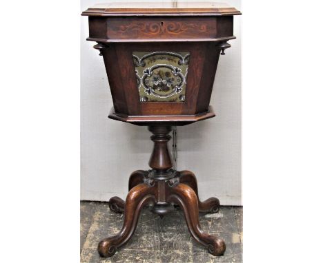 A Victorian walnut ladies sewing table, the rising lid revealing a segmented interior, the tapering panels incorporating a ta