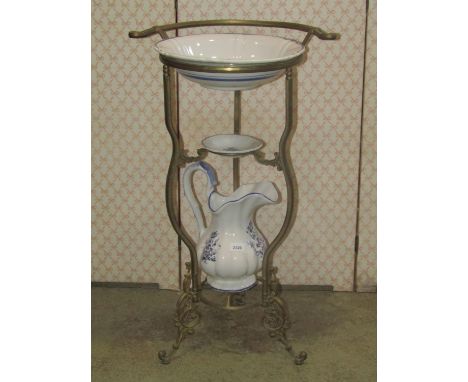 A Victorian style floorstanding washstand, the cast gilt metal frame with C scroll and acanthus detail supporting a transfer 