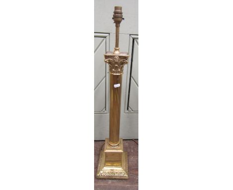 A brass table lamp with Corinthian column set on a square cut base 